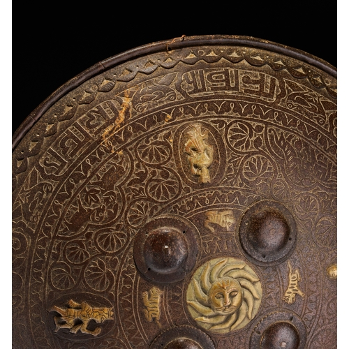 127 - AN INDO-PERSIAN GILT-METAL MOUNTED STEEL DHAL SHIELD, 19TH CENTURY This 19th-century Indo-Persian dh... 