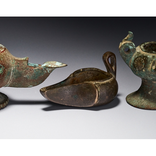 139 - A GROUP OF ISLAMIC BRONZE KHORASAN OIL LAMPS, IRAN, 12TH-13TH CENTURY The group includes various for... 