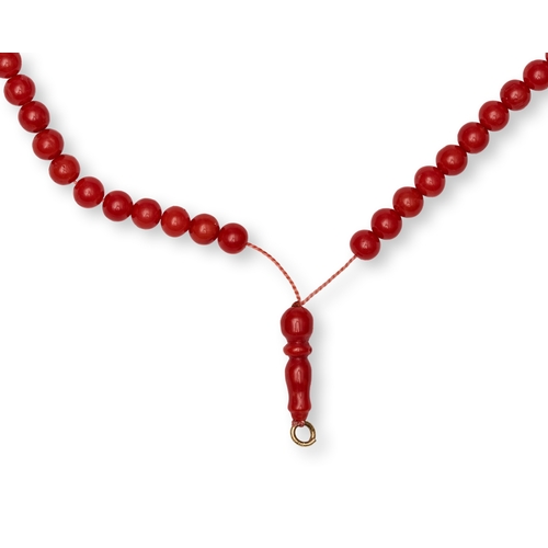 171 - A RED CORAL BEADED PRAYER STRAND (TASBIH) A red coral beaded strand configured as a set of prayer be... 