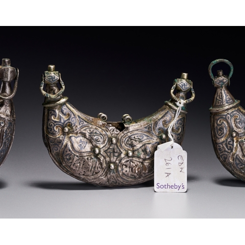 61 - A THREE SELJUK SILVER AND NIELLO PECTORAL AMULET CASES, IRAN, CIRCA 12TH CENTURY Comprising three cr... 