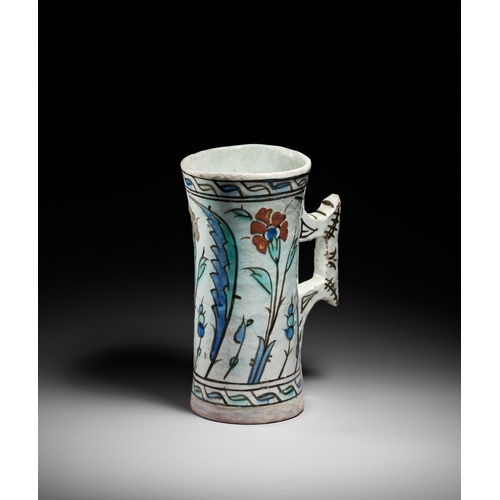 63 - AN IZNIK POTTERY TANKARD, OTTOMAN TURKEY, CIRCA 1600 This finely painted Iznik pottery tankard is a ... 