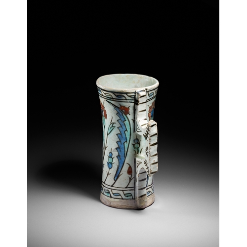 63 - AN IZNIK POTTERY TANKARD, OTTOMAN TURKEY, CIRCA 1600 This finely painted Iznik pottery tankard is a ... 