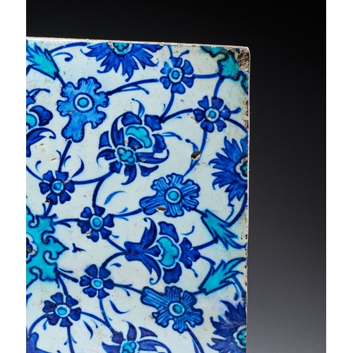 64 - AN IZNIK BLUE AND WHITE POTTERY TILE, TURKEY, 17TH CENTURY of square form, decorated in cobalt-blue,... 