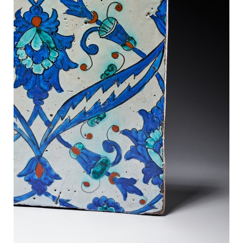 65 - AN IZNIK POTTERY TILE, OTTOMAN TURKEY, CIRCA 1580 The central composition features a large lobed pal... 