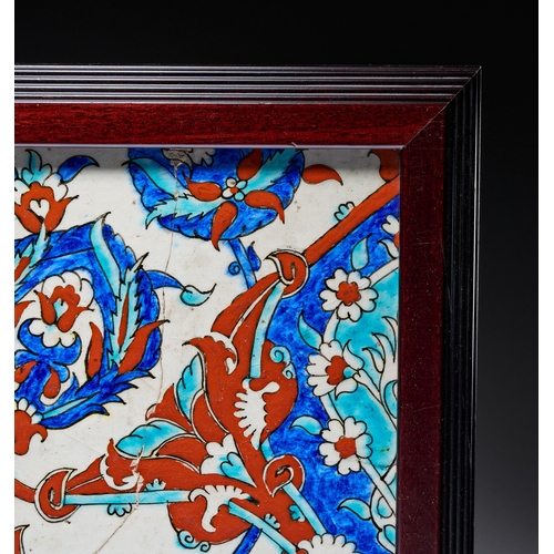 66 - AN IZNIK-STYLE POLYCHROME FRITWARE POTTERY TILE WITH FLORAL AND SAZ LEAF DECORATION, TURKEY, 19TH CE... 