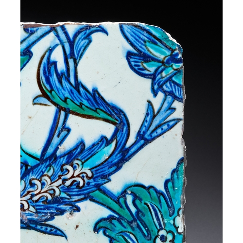 67 - A DAMASCUS POTTERY TILE WITH SAZ LEAF DESIGN, OTTOMAN SYRIA, 16TH - 17TH CENTURY The design is execu... 