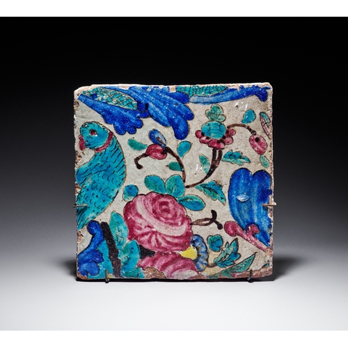 69 - A QAJAR POLYCHROME GLAZED CERAMIC TILE, PERSIA, 19TH CENTURY This square ceramic Qajar tile features... 