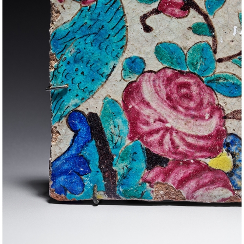 69 - A QAJAR POLYCHROME GLAZED CERAMIC TILE, PERSIA, 19TH CENTURY This square ceramic Qajar tile features... 