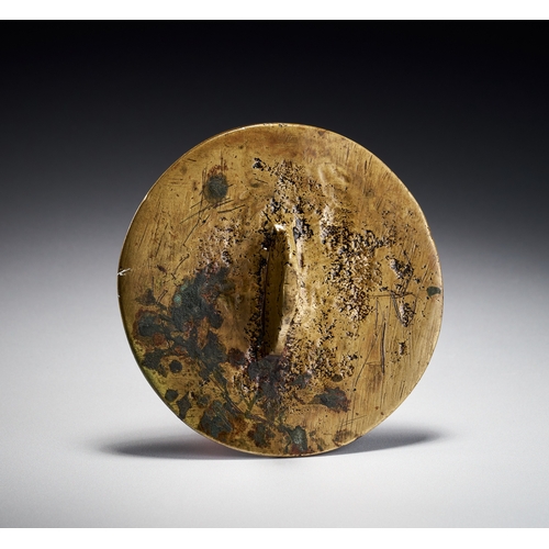 73 - A PERSIAN ENGRAVED BRASS TALISMANIC PLAQUE WITH THE NAMES OF THE TWELVE IMAMS, 19TH CENTURY This cir... 