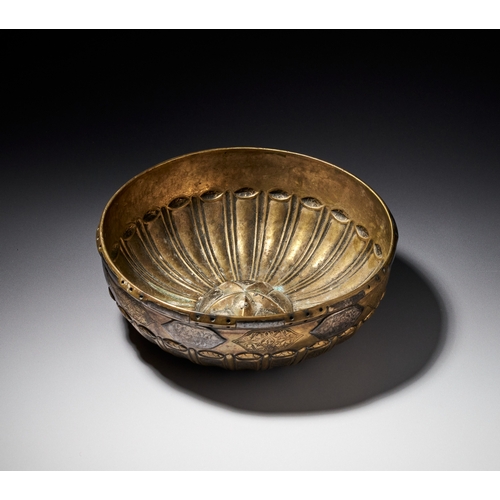 76 - A SILVER INLAID OTTOMAN HAMMAM BOWL, TURKEY, 18TH CENTURY This shallow brass bowl features a gadroon... 
