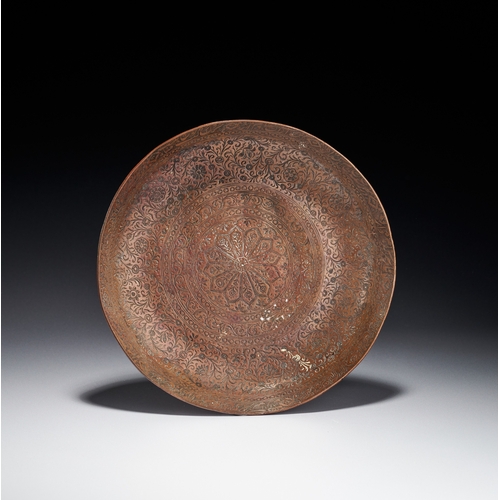 78 - AN ENGRAVED AND TINNED COPPER PLATE, KASHMIR INDIA, 19TH CENTURY This circular plate is constructed ... 
