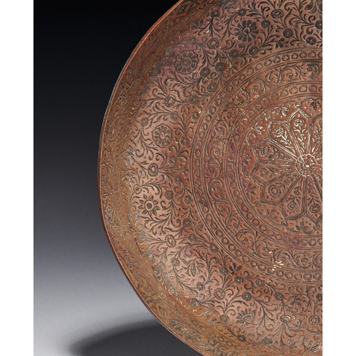 78 - AN ENGRAVED AND TINNED COPPER PLATE, KASHMIR INDIA, 19TH CENTURY This circular plate is constructed ... 