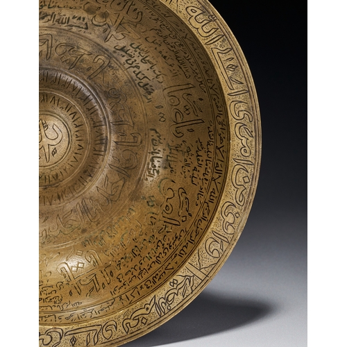 80 - AN ENGRAVED BRASS MAGIC BOWL, INDIA DECCAN, 18TH CENTURY This engraved brass magic bowl is a talisma... 