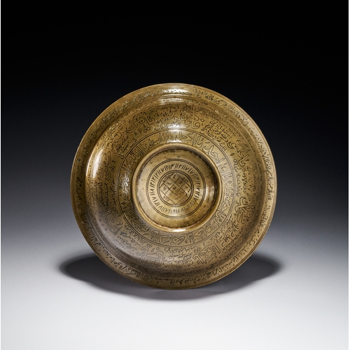 80 - AN ENGRAVED BRASS MAGIC BOWL, INDIA DECCAN, 18TH CENTURY This engraved brass magic bowl is a talisma... 