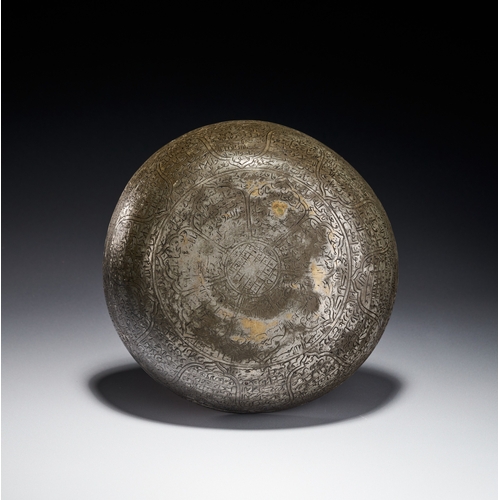 81 - A SAFAVID ENGRAVED COPPER MAGIC BOWL, PERSIA, 17TH - 18TH CENTURY This magic bowl is a hemispherical... 