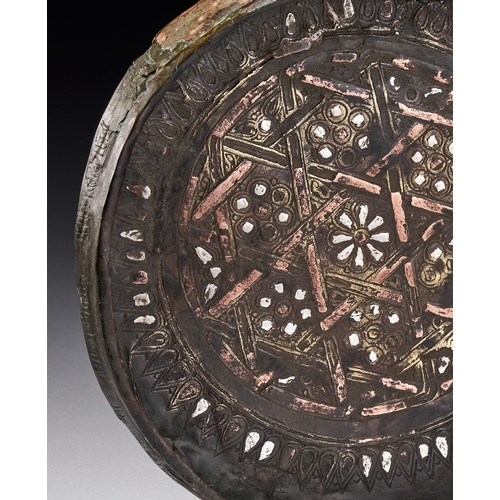 86 - A SELJUK SILVER AND COPPER INLAID BRONZE DISH, KHURASAN PERSIA, 12TH - 13TH CENTURY Features decorat... 