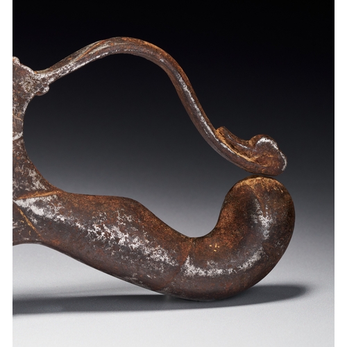 90 - A BRONZE DECCAN SWORD HANDLE, INDIA, 17TH CENTURY The hilt features a recurved knuckle guard that te... 