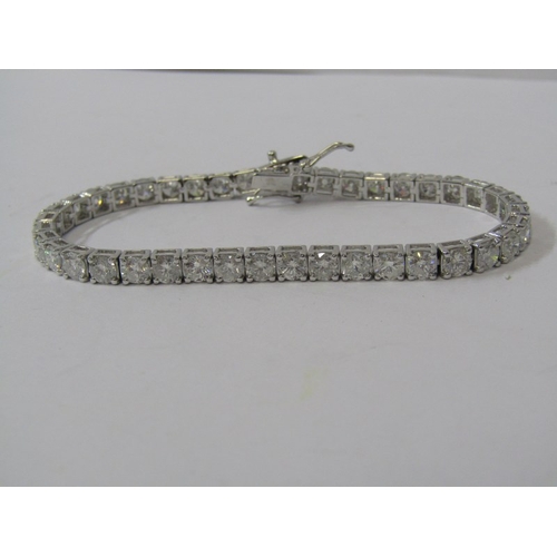 388 - 18ct WHITE GOLD DIAMOND LINE BRACELET, approx 10.1ct of well matched brilliant cut diamonds of good ... 