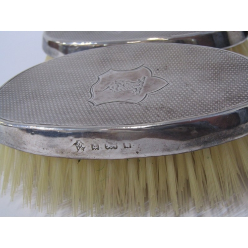 44 - SILVER BACKED GENTS BRUSHES, pair of oval engine turned decorated brushes, indistinct assay marks