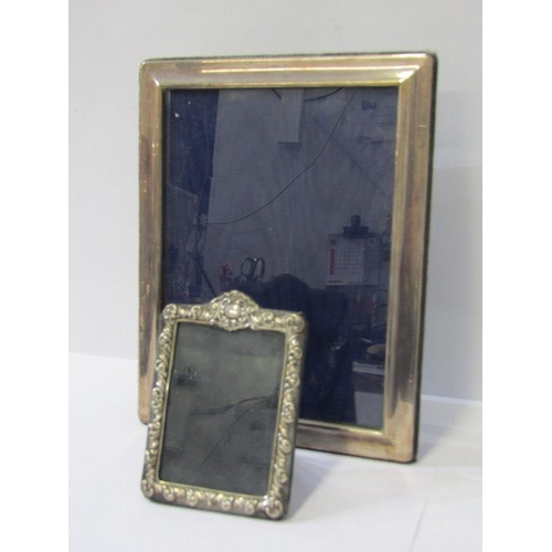 37 - SILVER PHOTO FRAMES, rectangular 24cm plain framed easel photo frame, together with smaller ornate p... 