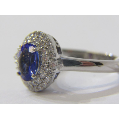 134 - IMPRESSIVE TANZANITE & DIAMOND CLUSTER RING, 18ct white gold ring, set a central oval tanzanite, sur... 