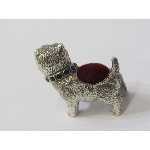 211 - A NOVELTY PIN CUSHION, a sterling silver pin cushion in the form of a Westie with red stone set eyes... 