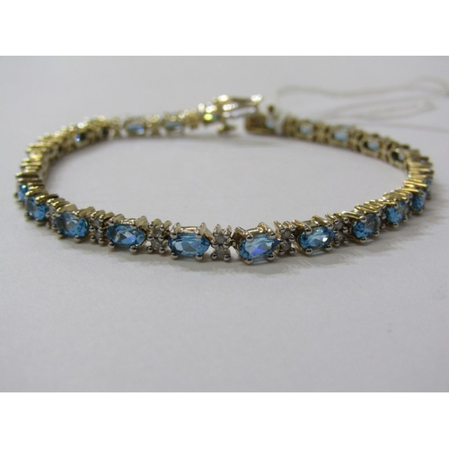 230 - IMPRESSIVE BLUE TOPAZ & DIAMOND BRACELET, set in 9ct yellow gold, set 25 blue topaz interspersed by ... 