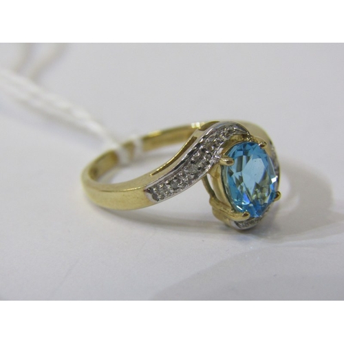 233 - TOPAZ & DIAMOND RING, 9ct yellow gold ring set with a large oval topaz with diamond shoulders in a c... 