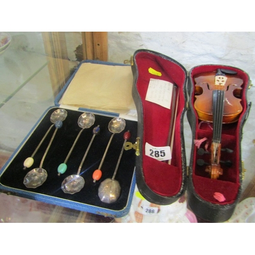 285 - CASED MINIATURE VIOLIN & BOW, together with vintage cased set of 6 coffee spoons