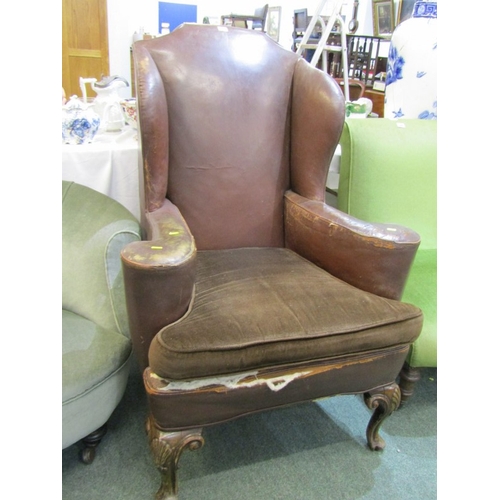 454 - VINTAGE LEATHER ARMCHAIR, vintage brown leather wingback armchair, with brown upholstered cushion, o... 