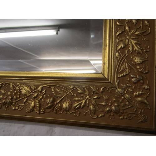 465 - BEVEL EDGED MIRROR, rectangular form in gilt foliate frame, 92cm width