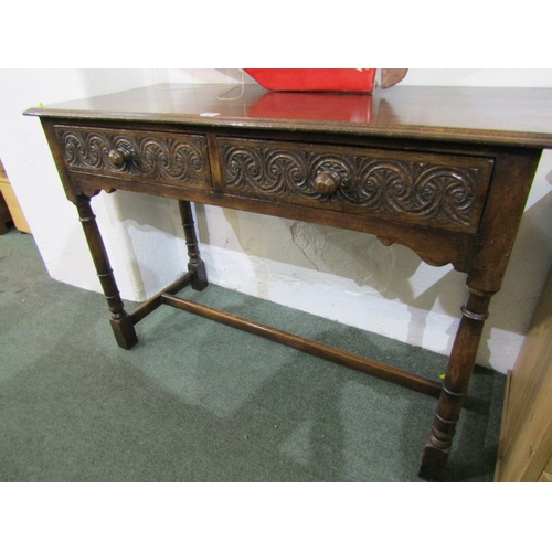 495 - OAK SIDE TABLE, oak twin drawer side cabinet with carved decoration to drawer fronts, 128cm width