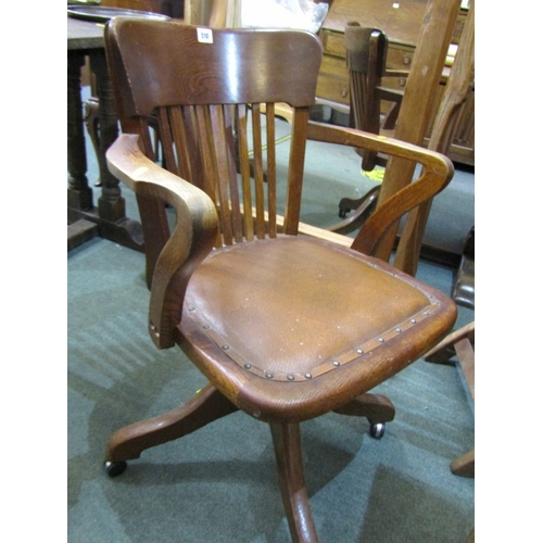 510 - VINTAGE OAK OFFICE CHAIR, oak framed swivel armchair with leather seat on castor feet