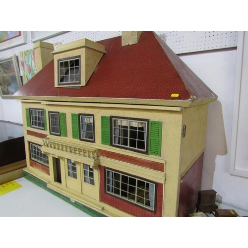 218 - A 1920's TRIANG DOLLS HOUSE, an impressive dolls house by Triang and retailed by Hamleys, 113cm widt... 