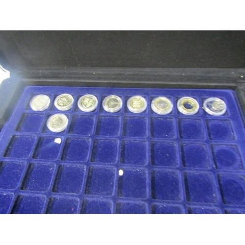 22 - ROUND POUNDS;  a collection of £1 coins x 87, from the United Kingdom, on trays in an aluminium coin... 