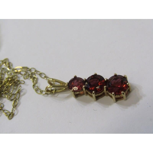 273 - 9ct GOLD PENDANT, 3 stone graduated garnet pendant set in 9ct gold on a gold fine link 20