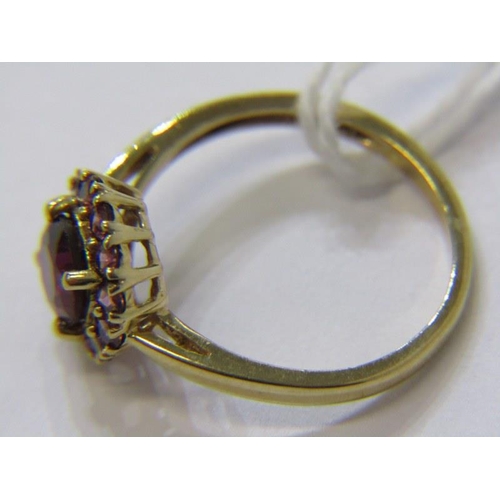 294 - AMETHYST CLUSTER RING, 9ct yellow gold ring, set a circular amethyst, within a cluster of further am... 