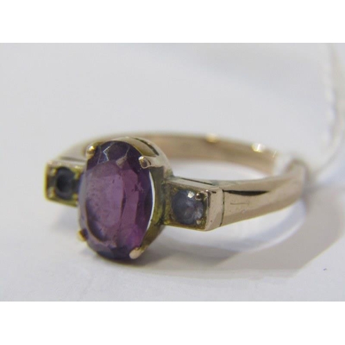 336 - AMETHYST RING, 9ct yellow gold ring set an oval amethyst with a pair of blue sapphires to either sid... 