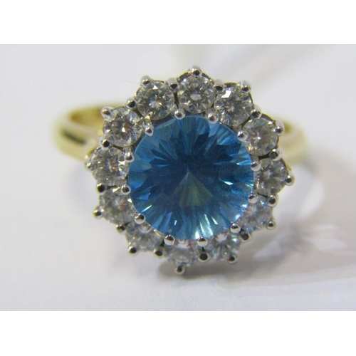 150 - 18ct YELLOW GOLD BLUE TOPAZ & DIAMOND CLUSTER RING, principal round cut blue topaz in excess of 2 ca... 