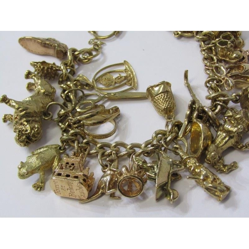 174 - 9ct GOLD CHARM BRACELET, approx. 26 charms in total, weighing 65.9 grams, charms including bulldog, ... 