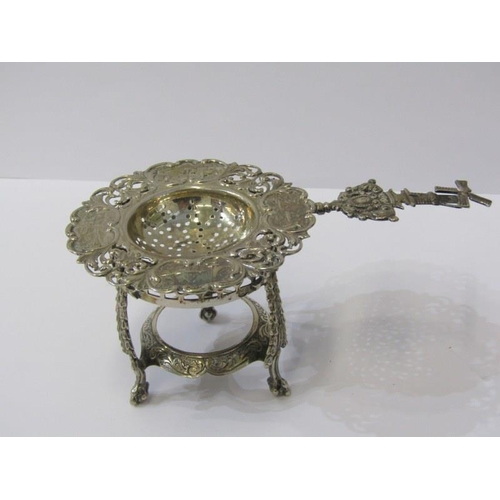 3 - CONTINENTAL SILVER TEA STRAINER ON STAND, tea strainer decorated cartouches of Royal scenes within a... 