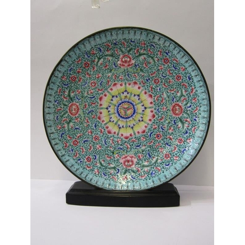 535 - CANTON ENAMEL, a turquoise ground shallow dish decorated with a field of flowers 33cms diameter