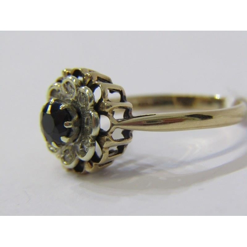 81 - 9ct YELLOW GOLD SAPPHIRE & DIAMOND FLOWER STYLE RING, principal brilliant cut sapphire surrounded by... 