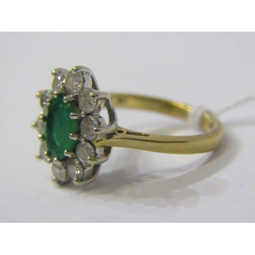 83 - 18ct YELLOW GOLD EMERALD & DIAMOND CLUSTER RING, principal oval cut emerald, surrounded by well matc... 