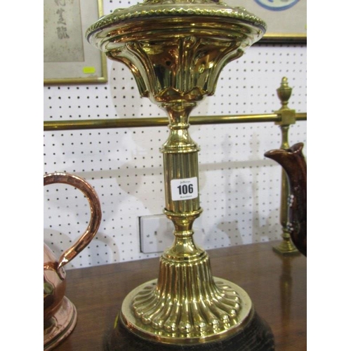 106 - VICTORIAN OIL LAMP, an attractive embossed brass circular based oil lamp with frosted glass shade