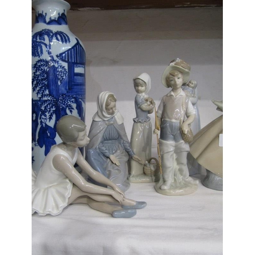 11 - LLADRO, a Lladro figure of a Fisherman with rod and basket; together with 5 Nao figures including Ba... 