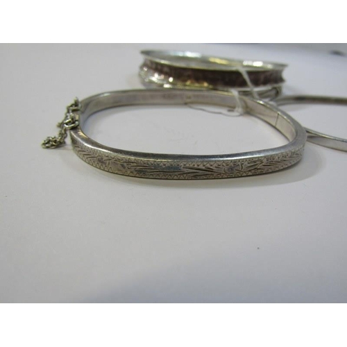 140 - SILVER BANGLES, 4 assorted silver bangles, including 2 hinged bangles and 2 others with engraved dec... 