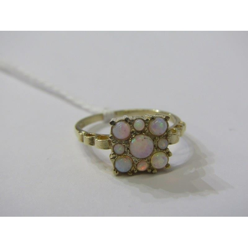 141 - OPAL RING, 9ct yellow gold ring set a cluster of 9 opals in a plaque style setting, size Q