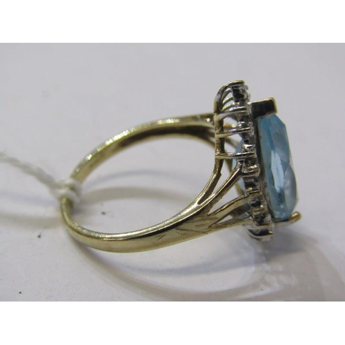 206 - AQUAMARINE & DIAMOND RING, 9ct yellow gold ring set a pear shaped aquamarine, surrounded by a cluste... 