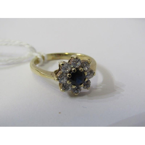 215 - 9ct GOLD CLUSTER RING, 9ct yellow gold ring set a blue stone to centre with clear stones to the oute... 